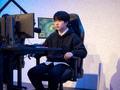 DOTA2 TI国际邀请赛预选赛现场，电竞选手在舞台上专注比赛