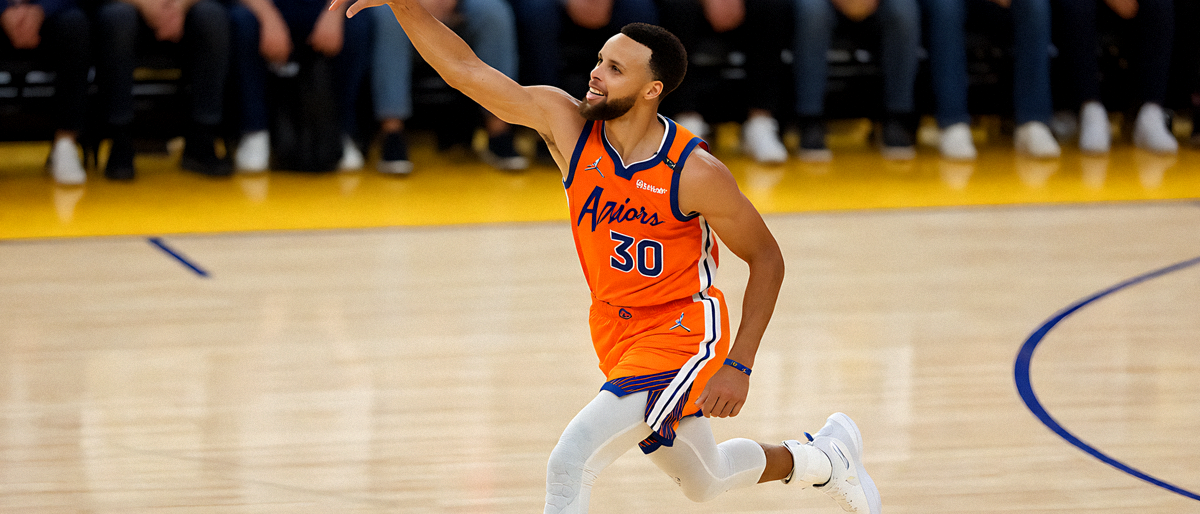 NBA篮球比赛中斯蒂芬·库里命中超远三分后的庆祝画面